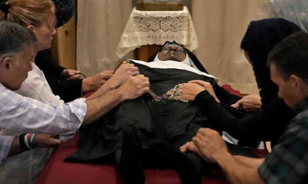 Thousands flock to see barely decomposed body of exhumed nun
